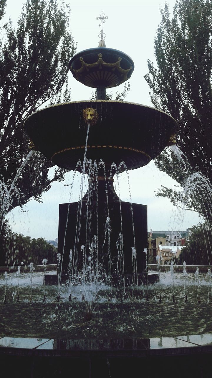 water, fountain, motion, low angle view, water park, no people, tree, outdoors, spraying, day, shower, nature, water slide, carousel, sky