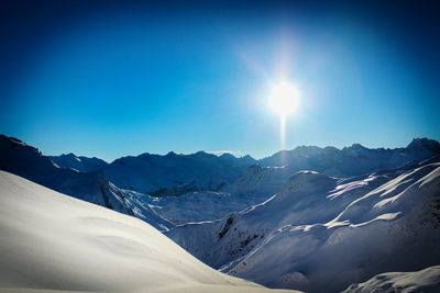 Scenic view of snow covered mountains against sky