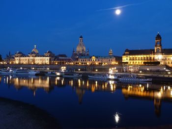Illuminated buildings with waterfront at night