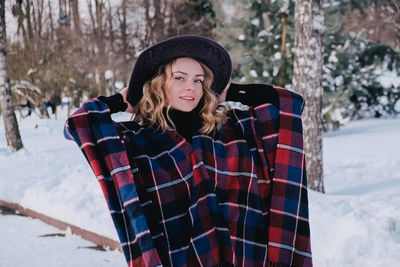 Portrait of teenage girl standing in snow