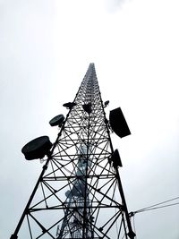 Low angle view of communications tower against sky