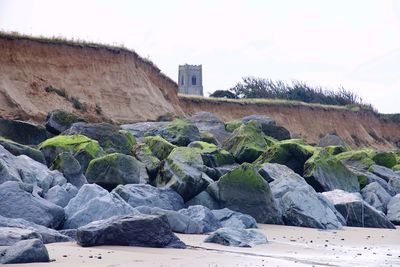 Rocks on shore against sky