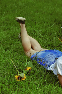 Low section of woman lying on grass