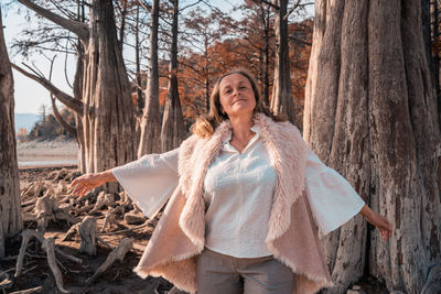 Portrait of a smiling young woman in forest
