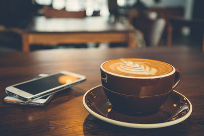 Close-up of coffee cup on table