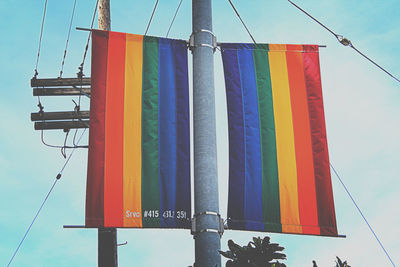 Low angle view of multi colored flags against clear sky