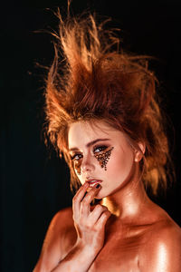 Portrait of young woman in bronze makeup 