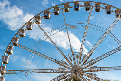 Low angle view of ferris wheel against sky