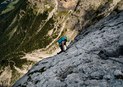 High angle view of person climbing on rock