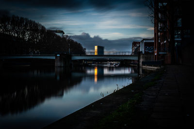 Bridge over river against sky at dusk