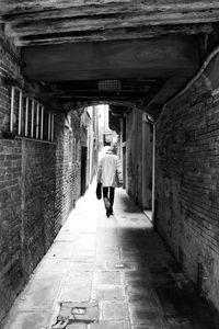 Rear view of woman walking on walkway