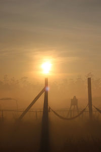 Silhouette bridge against sky during sunset