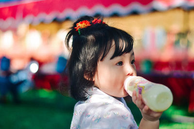 Close-up of girl blowing bubbles