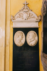 Close-up of angel statue against building