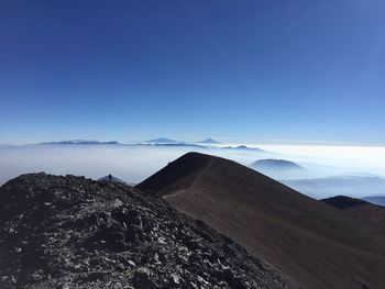 Scenic view of mountains against clear blue sky