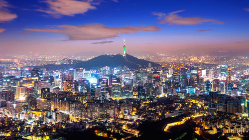 High angle view of city lit up at night