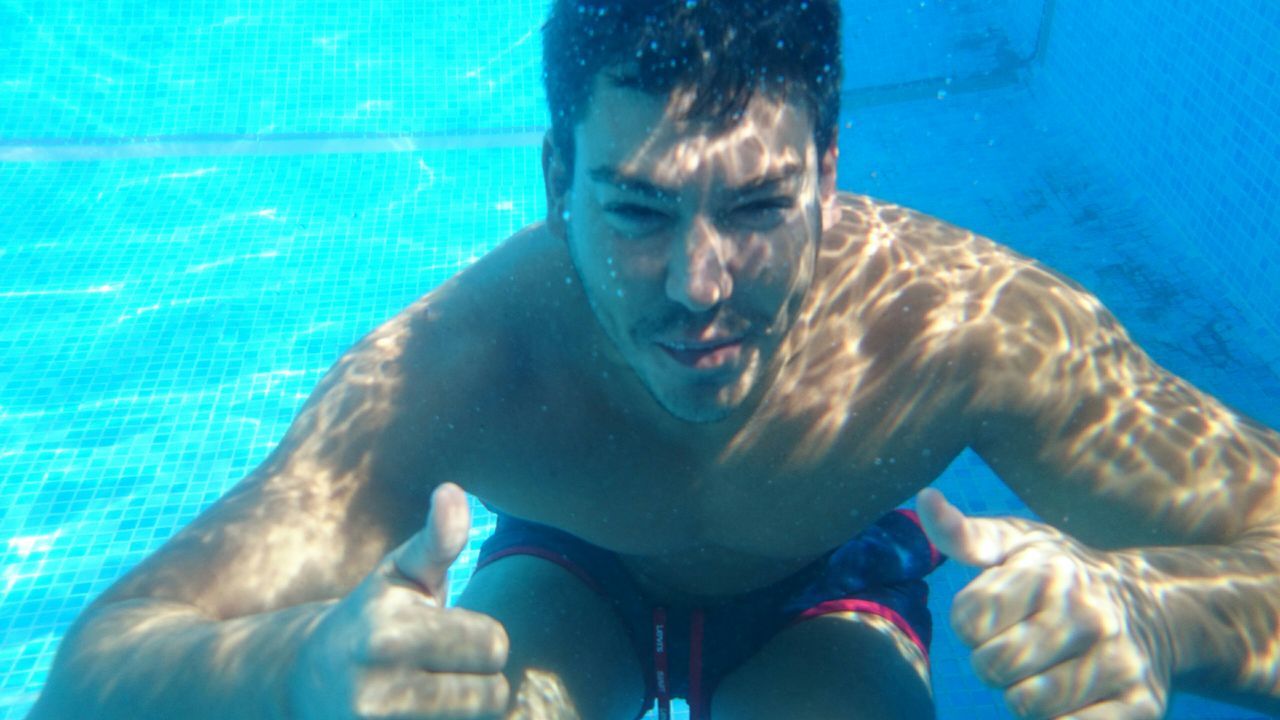 blue, lifestyles, water, leisure activity, swimming, swimming pool, underwater, shirtless, young adult, men, refreshment, headshot, sea, enjoyment, person, animal themes, looking at camera