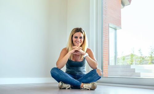 Portrait of young woman sitting at home