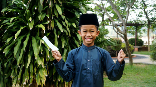 Portrait of a smiling young man standing outdoors