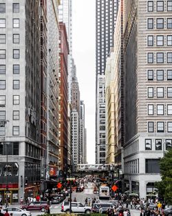 Traffic on city street amidst buildings