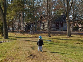 Rear view of man walking on field