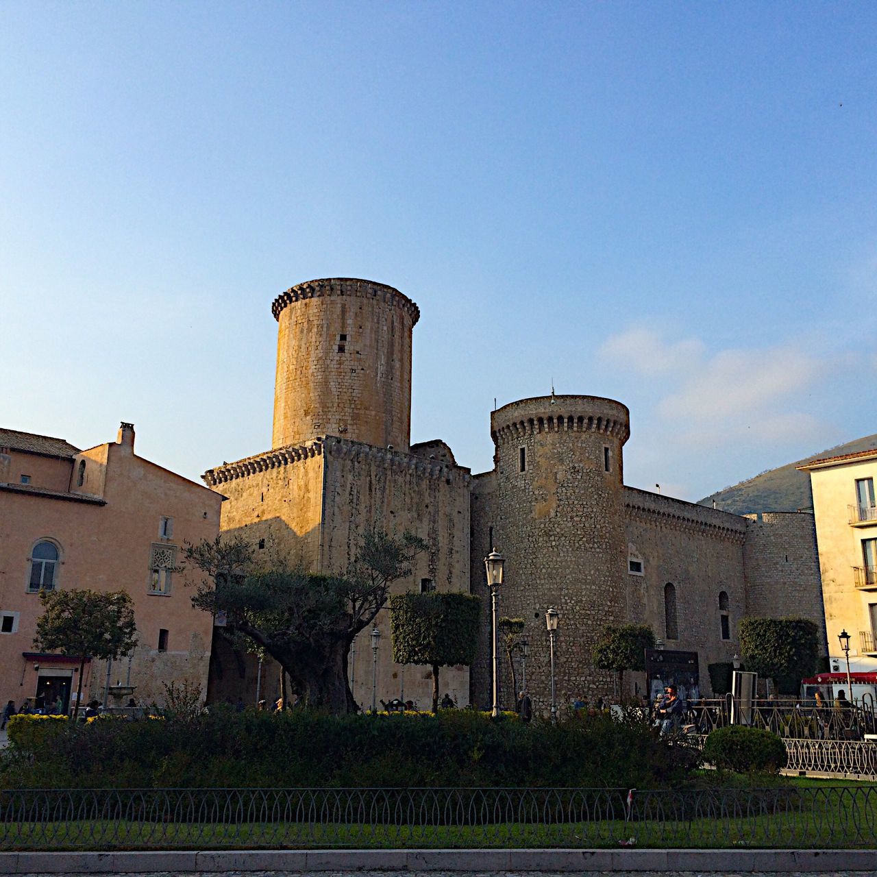 architecture, built structure, building exterior, clear sky, history, tower, low angle view, blue, copy space, famous place, travel destinations, old, day, the past, grass, sky, travel, tree, castle, tourism