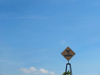 Road sign against sky