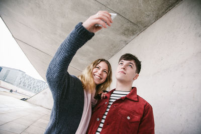 Portrait of young couple standing outdoors