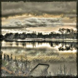 Scenic view of lake against cloudy sky