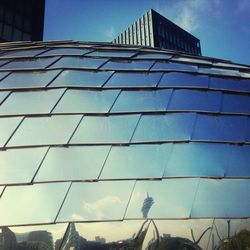 Low angle view of modern building against blue sky