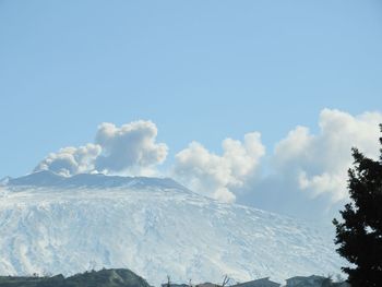 Low angle view of snowcapped mountain against sky