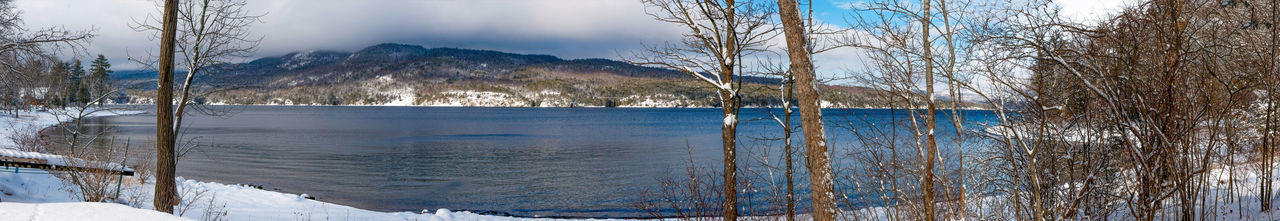 Scenic view of lake against sky during winter