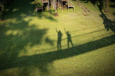 Shadow of people on field