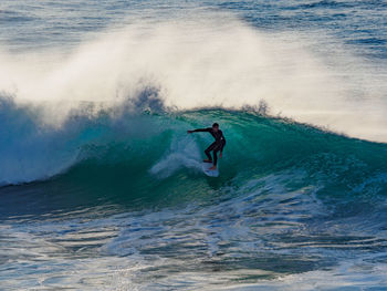 People surfing in sea