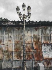 Low angle view of street light against building