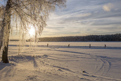 Scenic view of frozen landscape against sky during winter