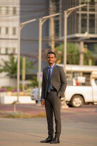 Portrait of businessman standing in city