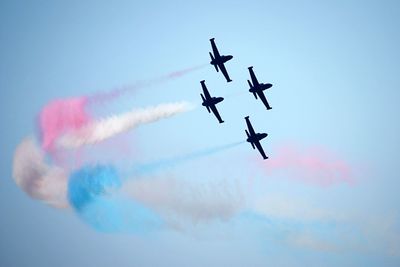Low angle view of airshow in sky