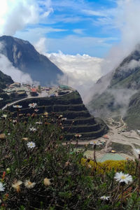 Scenic view of mountains against cloudy sky