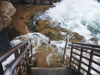 High angle view of water flowing through railing