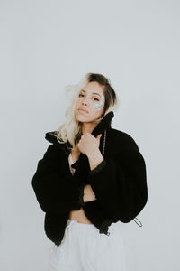 Portrait of a smiling young woman against white background