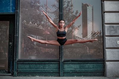 Full length of woman with arms raised