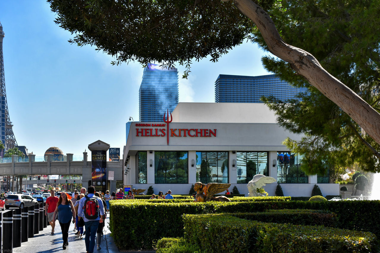 REAR VIEW OF PEOPLE WALKING ON BUILDING