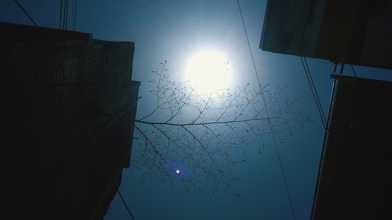 LOW ANGLE VIEW OF ILLUMINATED BUILDING AGAINST SKY