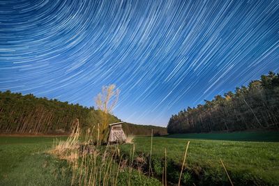 Scenic view of field against sky at night
