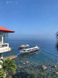 High angle view of townscape by sea against sky