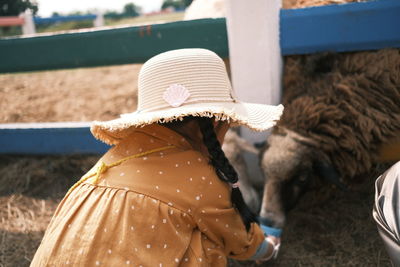 Rear view of woman with horse