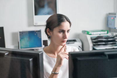 Concentrated asian woman radiologist woking in office in radiology department in clinic. 