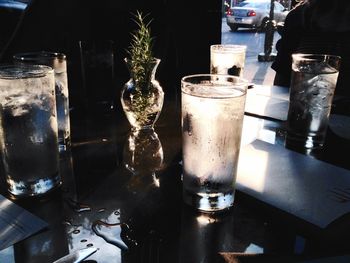 Condensed glasses and vase on table