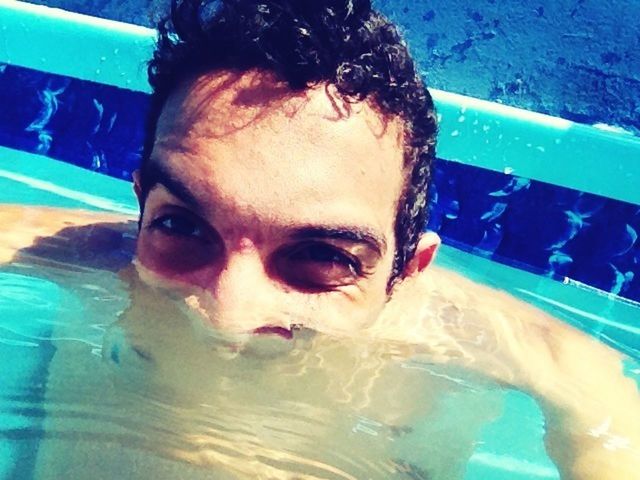 person, lifestyles, leisure activity, headshot, water, looking at camera, portrait, young adult, swimming pool, young men, close-up, shirtless, front view, blue, refreshment, mid adult, indoors, smiling